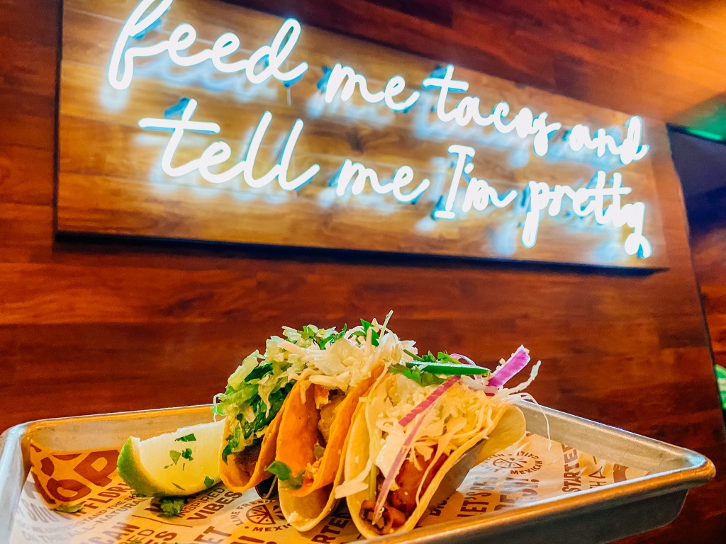 "Feed me tacos and tell me I'm pretty" sign with tacos at LIME Fresh Mexican Grill